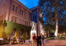 University Slams Post Glorifying Burning Murder bronze athlete statue on campus at dusk