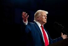 Trump’s 100% Hammer Drops Now A man in a suit gesturing during a speech