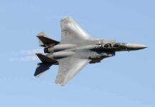 Flares Light Up the Sky Over New York fighter jet banking in clear sky