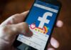 Texas Judge’s Facebook Fury Explodes Hand using smartphone with Facebook reactions on screen