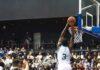 Rulebook Hole Stuns WNBA Brass Basketball player dunks the ball in a crowded arena