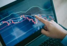 Federal Funding for Fetal Tissue Research Ends Hand pointing at stock chart on laptop screen