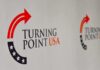 Campus Shuts Down. One Arena Doesn’t. Turning Point USA logo on a backdrop