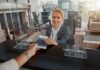 Hospital Hustle Busted — Visas Yanked airport check-in agent handing back a passport