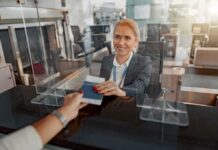 airport check-in agent handing back a passport