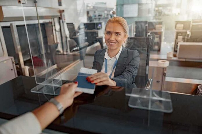 airport check-in agent handing back a passport