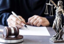 Judge Rants, Then Relents — Probation Judge writing at desk with gavel and Lady Justice statue