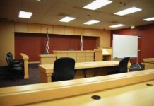 Starvation Death—Court Says Probation Interior view of an empty courtroom with wooden furniture and American flags