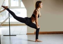 woman stretching at a ballet barre