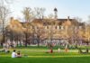 The Quiet Talks Behind A Major Endorsement Students relaxing on a campus quad in front of a brick academic building