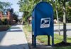 Medical Files Missing – Mailman Indicted Blue USPS mailbox on a suburban sidewalk