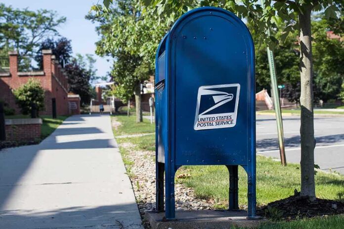shutterstock_1123464173 Blue USPS mailbox on a suburban sidewalk
