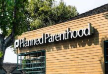Planned Parenthood clinic exterior with sign on wooden facade