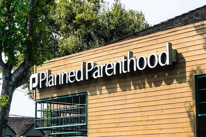 shutterstock_1153115801 Planned Parenthood clinic exterior with sign on wooden facade