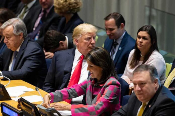 Donald Trump seated between António Guterres and Nikki Haley, with Mike Pompeo in the foreground at a meeting