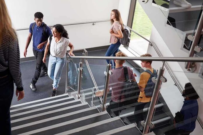shutterstock_1188887332 Students walking on a school staircase