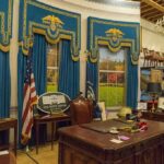 Double Standard Drumbeat After Biden Photo Dump Oval Office-style desk and decor in a museum display