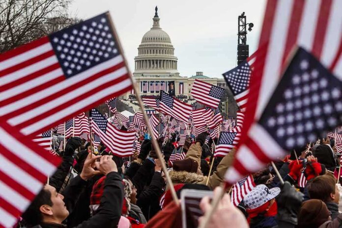 Crowd waving American flags near the U.S. Capitol