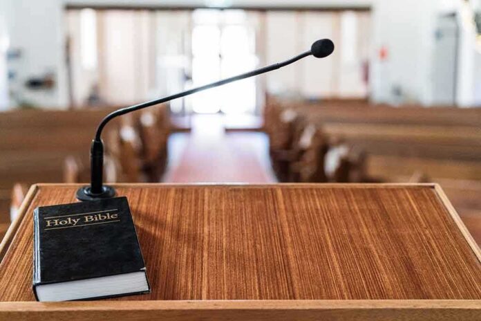 shutterstock_1271187499 Podium with microphone and Bible in a church