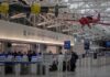 Armed Response Descends On Major U.S. Airport airport security checkpoint with passengers and hanging vintage airplanes