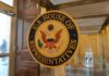 U.S. House of Representatives seal on a glass door