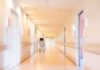 Hospital corridor with doors and medical cart