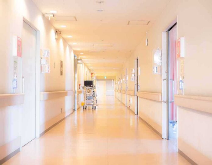 Hospital corridor with doors and medical cart