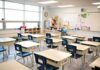 Empty classroom with rows of student desks and chairs