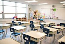Empty classroom with rows of student desks and chairs