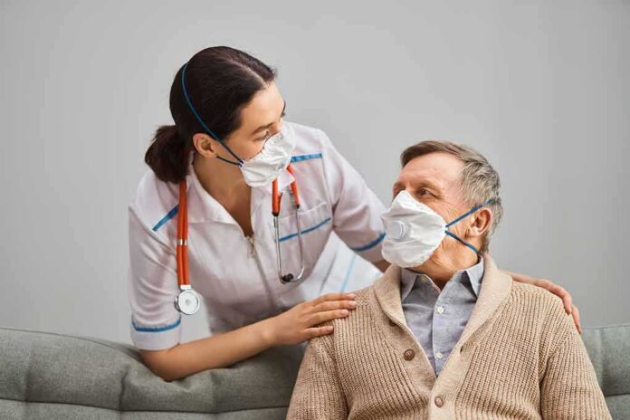 shutterstock_1690267378 nurse with stethoscope comforting elderly man wearing masks