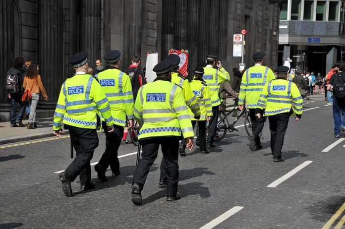 Police officers in high-visibility jackets walking on a city street