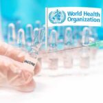 Deadly Ebola Strain—No Vaccine? WHO Declares Crisis Gloved hands holding vaccine vial and syringe near WHO banner