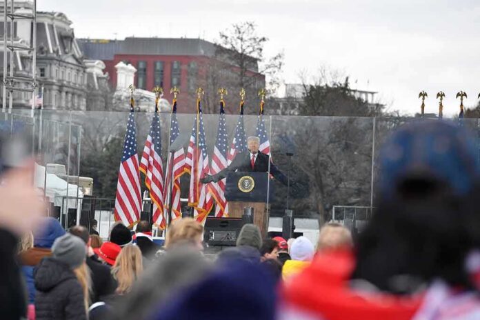 shutterstock_1890489670 speaker at presidential podium addressing crowd outdoors