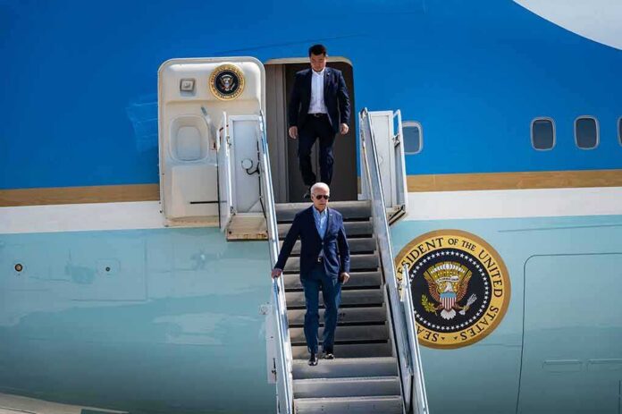 shutterstock_2041381268 Joe Biden descends Air Force One stairs with aide following