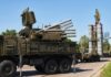 military air defense vehicles on a road