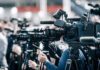 Thirty Homes Flee As Malibu Street Vanishes Broadcast cameras on tripods at a press event