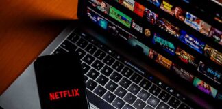 Smartphone with Netflix logo on a laptop keyboard