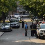 Parents Targeted After TEENS RIOT Police officers secure a residential street with patrol cars and yellow tape