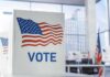 Cash-For-Votes Sting Shakes Los Angeles Voting booth with American flag design in a modern polling place