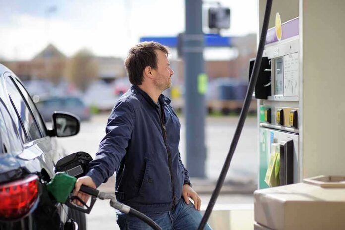 shutterstock_282565256 Man refueling a car at a gas station pump