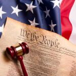 Immigration Brawl Meets Unbreakable Precedent U.S. Constitution with gavel on American flag
