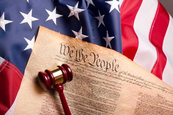 shutterstock_41853862 U.S. Constitution with gavel on American flag