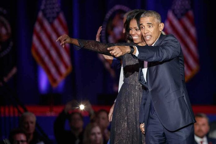shutterstock_560410630 Michelle Obama and Rob Nabors pointing on stage at an event