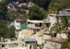 Hillside neighborhood with damaged concrete houses