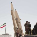 Outrageous Bounty on Trump—WHAT? Soldiers stand beside large missiles at an outdoor display