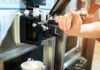 soft serve machine dispensing ice cream into a paper cup