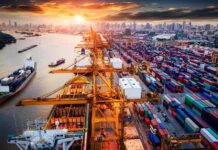 Industrial Juggernaut Supercharges PLAN Container port with cranes and cargo ships at sunset