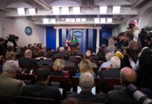 Iran Applauds Gabbard’s Move—What’s Trump’s Next Step? Press secretary at podium addressing reporters in briefing room