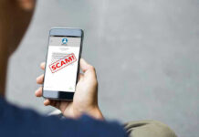 Person reading a scam message on a smartphone.