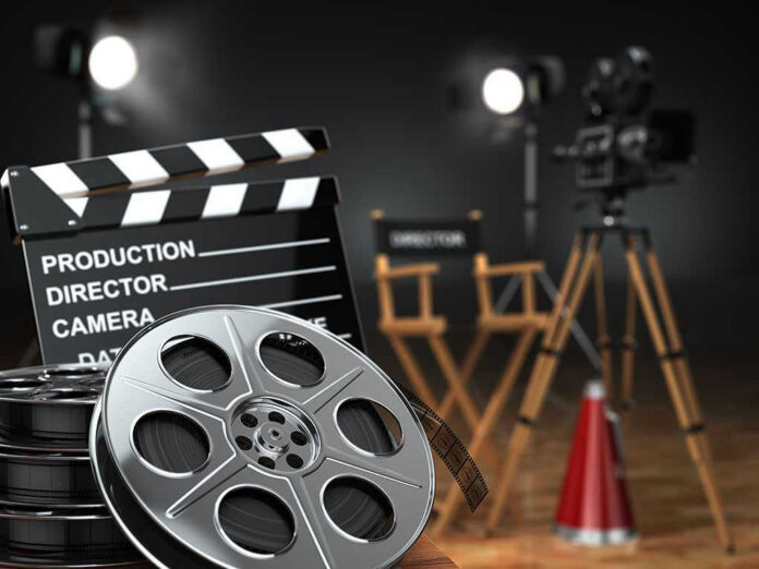 Movie set with film reels and clapperboard.